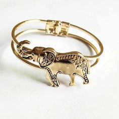 Expertly crafted by hand, this elephant cuff bracelet/bangle is a unique and stunning addition to any jewelry collection. With intricate details and quality craftsmanship, it is sure to make a statement and add a touch of elegance to any outfit. Experience the beauty and artistry of handcrafted jewelry with this stunning accessory. Adjustable Metal Bangle With Intricate Design, Gold Bohemian Cuff Bracelet, Bohemian Metal Bangle Cuff Bracelet, Elegant Bangle Bracelets With Unique Design, Gold Bangle Bracelet With Unique Design, Elegant Bangle With Unique Design, Unique Design Cuff Bracelet Bangle As Gift, Elegant Bracelets With Unique Design As Gift, Elegant Bracelets With Unique Design For Gift