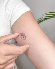 a person with a small tattoo on their arm