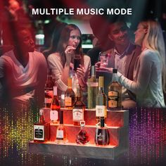 a group of people sitting at a table with bottles on it and the words multiple music mode