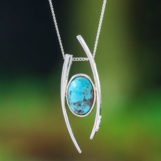 An elegant pendant enhances the sophisticated beauty of this choker necklace by Mexico's Ezequiel Tapia. The artisan draws inspiration from modern trends to create this sterling silver accessory, polishing everything for a glowing look. The central piece is reconstituted turquoise stone, whose oval shape and refreshing colors capture the serene essence of an ethereal lagoon. Unique Polished Turquoise Necklace, Modern Oval Turquoise Jewelry, Modern Turquoise Oval Jewelry, Sterling Silver Turquoise Necklace With Large Pendant, Modern Sterling Silver Oval Pendant Jewelry, Modern Turquoise Sterling Silver Jewelry, Elegant Turquoise Teardrop Pendant Jewelry, Elegant Turquoise Necklace With Round Pendant, Elegant Turquoise Gemstone Necklace With Oval Pendant