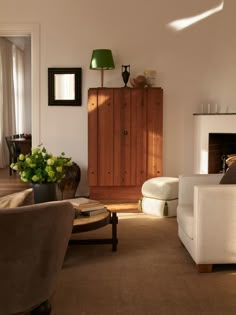 a living room filled with furniture and a fire place