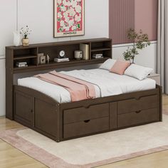 a bed with two drawers underneath it and a pink rug on the floor next to it