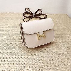 a white purse sitting on top of a table