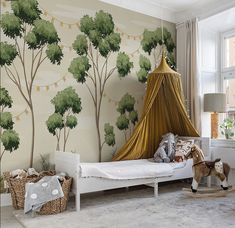 a child's bedroom with a canopy bed and wallpapered trees on the walls