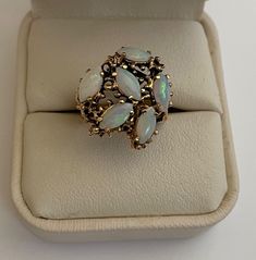 VINTAGE 14K YELLOW GOLD RING w/ 6 OPALS and BEAUTIFUL FILIGREE WORK Marked ATL, or Atlantic Jewelry Co. in New York City. Size 6 (or just under -- see Photo) Gorgeous Vintage Condition! Clearly marked 14K and ATL Filigree work going up the sides looks like (upside down) hearts. Stunning filigree open work on the top with the opals -- the gold on top and sides has an "antique" finish. A wonderful statement piece to add to your collection. Please see Photos for complete description and condition. Opal Ring, Yellow Gold Ring, Antique Finish, Opal Rings, Yellow Gold Rings, Vintage Watches, On The Top, Antique Jewelry, The Gold