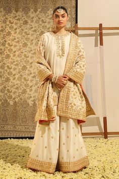 Ivory straight kurta with gota patti, dabka, zardozi embroidery in floral pattern. Paired with a sharara with embroidered buttis and dupatta with floral jaal embroidery. - Aza Fashions Traditional Cream Sharara With Straight Kurta, Bollywood Style Off White Traditional Wear With Gota Work, Traditional Gold Palazzo Set With Chikankari Embroidery, Wedding Palazzo Set With Cutdana On Straight Kurta, Off White Palazzo Set With Zari Work For Festivals, Off White Sharara With Cutdana For Diwali, Off White Cutdana Sharara For Diwali, Festive Cream Sharara With Gota Work, Traditional Cream Palazzo Set For Festive Occasions