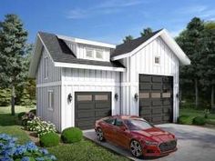 a red car is parked in front of a white two - story house with garage