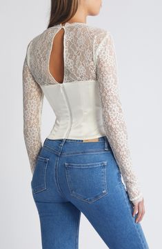 Sheer lace sleeves enhance the romance of a corset-inspired top fashioned with a smooth satin bodice and structured boning. Back zip; keyhole with button-and-loop closure Square neck Long sleeves Lined, with structured boning 100% polyester with 84% polyamide, 16% elastane and 90% polyamide, 10% elastane contrasts Dry clean Imported Wedding Fitted Corset With Lace Closure, Fitted Feminine Corset With Lace Bodice, Feminine Fitted Corset With Lace Bodice, Elegant Fitted Top With Lace Closure, Elegant Fitted Tops With Lace Closure, Chic Fitted Top With Lace Bodice, Elegant Fitted Corset With Lace Trim, Fitted Lace Top With Lace Closure, Elegant Fitted Lace Top With Lace Closure