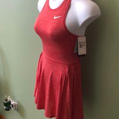 a woman's tennis dress on display in a room with green walls and white trim