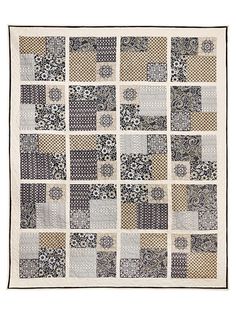 a black and white patchwork quilt with many different designs on the front, back and sides