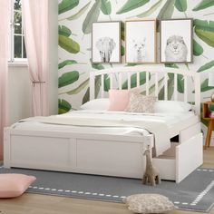 a white bed sitting in a bedroom next to a pink chair and table with two pictures on the wall