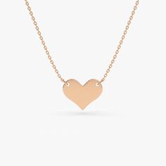 Gold KT: 14K
Pendant - 8.5mm x 10mm

A tiny 14K gold heart hangs daintily from a thin gold chain. Create a truly perfect self-love talisman. Choose from: Rose Gold, Yellow Gold, and White Rhodium. In the hustle and bustle of everyday, sometimes we can just forget to be nice to ourselves. Treat yourself to this pretty little gold heart pendant necklace and celebrate your best relationship. Heart Pendant Gold, Gold Heart Necklace, The Hustle, Gold Heart, Best Relationship, Necklace Sizes, Heart Pendant Necklace, Heart Of Gold, Gold Yellow