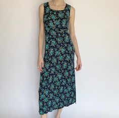 "Product Details: Adorable vintage blue floral dress. Fabric does stretch, can different sizes depending on how baggy you want the fit. Perfect picnic or summertime dress! Lays about mid-calf. Super lightweight and airy.  Brand: Unknown Material: Unknown Marked Size: Unknown Measurements: Bust: 16.5\" Waist: 16\" Height: 16.5\" Length: 50\" Amazing condition. Model: 5'9\" All sales are final." Blue Midi Dress With Ditsy Floral Print For Summer, Vintage Blue Maxi Dress For Summer, Blue Sleeveless Midi Dress With Ditsy Floral Print, Blue Maxi Dress With Ditsy Floral Print For Summer, Blue Ditsy Floral Print Maxi Dress For Garden Party, Casual Blue Floral Dress For Garden Party, Blue Floral Print Maxi Dress, Casual Blue Floral Midi Dress, Blue Floral Midi Dress Casual Style