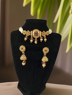 "Rajwadi Choker made in Brass with 22 karat Gold plating with Kundan stones, Meenakari and colored beads, Handcrafted To Perfection, Lightweight jewelry, Adjustable Fitting around the neck with Golden extension dori" Dimension: 6" end to end necklace length and 1.2" width Earrings: 1.5" long Weight: 1.2 oz and w/ packaging 2.2 oz Traditional Adjustable Gold Plated Jewelry, Festive Hand Set Choker Necklace, Adjustable Traditional Gold-plated Jewelry, Festive Hand-set Choker Necklace, Elegant Festive Choker With Latkans, Elegant Adjustable Choker For Ceremonial Occasions, Festive Bridal Choker With Intricate Design, Festive Choker For Celebration, Intricate Design Kundan Choker Necklace For Celebration