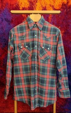 "✰ 70s Western shirt at it's finest ✰ classic tartan plaid ✰ Beautiful pearl snaps ✰ Thicker cotton  Circa: 1970s Material: cotton Label: DEE CEE, made in USA - MEASUREMENTS- (measurements taken flat) please refer to listing images for how we measure Label size: 15.5/33 Length: 30\" Shoulder: 18\" Chest: 21.5\" Hem: 21.5\" (unfinished) Sleeve: 24\" Condition:  Beautiful, like new condition *for more listings, please click here: https://www.etsy.com/shop/MonarkVintage Vintage condition usually me 70s Western, Geometric Cardigan, Cowboy Shirt, Cotton Labels, Cowboys Shirt, Western Shirt, Western Shirts, Tartan Plaid, Western Style