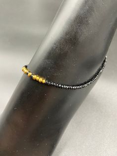 Black crystal with gold  beads single anklet Handmade jewelry  Official Website globusfashions.com 🌸 S H O P . M O R E . S T Y L E S  🌸 https://www.etsy.com/shop/Globusfashions Necklaces -  https://www.etsy.com/shop/Globusfashions?section_id=18712263 Bracelets - https://www.etsy.com/shop/Globusfashions?section_id=18969767 Pendant Sets - https://www.etsy.com/shop/Globusfashions?section_id=18707402 Tikka - https://www.etsy.com/shop/Globusfashions?section_id=20096802 Bangles - https://www.etsy.co Gold Beaded Anklets For Party, Gold Beaded Bracelets With Tiny Beads For Party, Black Bracelets With Tiny Beads For Party, Gold Bracelets For Party, Gold Bracelets With Tiny Beads For Party, Gold Bracelet With Tiny Beads For Party, Gold Hand-strung Beaded Bracelets For Party, Hand-strung Gold Beaded Bracelets For Parties, Gold Round Beads Crystal Bracelet For Party