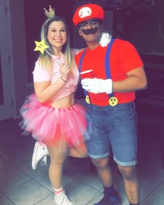 a man and woman dressed up as mario and princess peach are posing for the camera