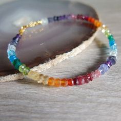 This rainbow bracelet has a great variety of natural gemstones. They are : Aquamarine, raw Ruby, Garnet, Amethyst, Iolite, Peridot, Citrine, Carnelian, Red Agate, Apatite , blue sapphire rock Quartz, Tanzanite and emerald A gorgeous fusion of colors in this multi stone precious  bracelet. A riot of vivid  colors  in ombre design I chose and  lined the gemstones to obtain this unique shaded colorful precious bracelet. It will be beautiful alone or together with other gemstones stacking bracelets The gemstone beads are strung on the highest quality jewelery strand  beading wire and the bracelet closes with a gold filled  spring ring clasp All the gemstones are aproximately 3-4     mm - approximately The length of the bracelet is 18,00 cm   inch  7.08   You will receive the exact bracelet in Raw Ruby, Color Bracelet, Ombre Design, Stacking Bracelets, Rainbow Gemstones, Rainbow Bracelet, Precious Jewels, Beading Wire, Red Agate