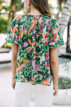 We hope you have all the plans for this blouse! It's sure to take you from the office to the beach side restaurant! That tropical floral print is so fun and colorful! Round neckline Smocked yoke Button keyhole back Short bubble sleeves Tropical floral print No stretch Savannah is wearing the small. Vacation Tops With Smocked Bodice And Short Sleeves, Vacation Smocked Bodice Short Sleeve Blouse, V-neck Blouse With Smocked Back For Vacation, Summer Tops With Smocked Back And Short Sleeves, Multicolor Casual Smocked Short Sleeve Top, Vacation Blouse With Smocked Back And Short Sleeves, Short Sleeve Blouse With Smocked Back For Vacation, V-neck Blouse With Smocked Bodice For Vacation, Multicolor Smocked Top For Beach In Summer