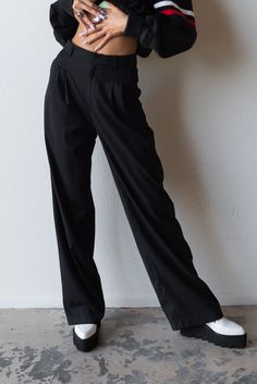 Meet your new favorite pants. Timeless and trendy are the Perfect Trouser featuring a loose fit with front pleat detail and side pockets. Color: Black Loose Fit Front Pleats Pockets Wide Leg Mid Rise Rayon Blend Model is 5'10", size 25/26 in bottoms and is wearing size small Classic Black Cargo Pants For Work, Baggy Wide-leg Dress Pants For Workwear, Baggy Wide-leg Pants For Work, Baggy Dress Pants For Work, Baggy Black Work Pants, Black Pleated Tapered Leg Pants, Black Straight Leg Pleated Pants, Black Straight-leg Pleated Pants, Baggy High-waisted Wide Leg Pants For Work