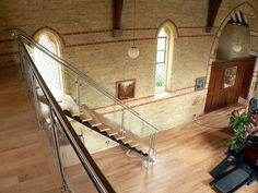 an overhead view of a church with stained glass windows and metal handrails that lead up to the second floor