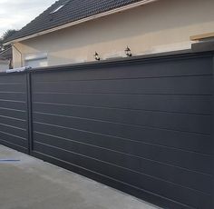 a large black garage door on the side of a house