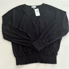 Women’s Evereve Black V-Neck Smocked Long-Sleeved Top, Size L. Never Worn, New With Tags. Fall V-neck Ruched Smocked Top, V-neck Smocked Top For Brunch, Solid V-neck Top With Smocked Bodice, Black Long Sleeve Tops With Elastic Sleeves, V-neck Top With Smocked Bodice, Black Tops With Elastic Sleeves For Fall, Fall V-neck Blouse With Smocked Bodice, Trendy Long Sleeve Smocked Top With Elastic Sleeves, Trendy Smocked Top With Long Elastic Sleeves