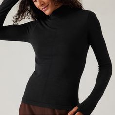 Athleta Ascent Seamless Turtleneck. Size Small. New With Tags. For: Commute, Travel, Hiking In Cold Weather Climates Feel: New And Improved Merino Wool Yarn Is Ultra-Soft, Lightweight, And Resists Pilling Fave: Pointelle Stitching Down The Front For Breathability Close-To-Body Fit Make It The Perfect Base Layer Light Mesh Structure On Back Facilitates Ventilation Wool/Nylon Seamless: Beyond-Soft, Chafe-Free Fabric Stretches With Every Move Breathable: Airflow Moves Easily Through The Garment Machine Wash And Lay Flat To Dry. Fitted Next To The Body Regular Length, Hits At Low Hip T-Neck Body Length In Size Medium: Regular: 22" Seamless Athleisure Tops For Layering, Black Compressive Seamless Top, Seamless Fitted Activewear For Layering, Functional Seamless Black Tops, Athleisure Seamless Stretch Tops, High Neck Athleisure Activewear For Gym, Seamless Stretch Athleisure Tops, Sporty Tops With Minimal Stretch For Layering, Athleisure Tops For Pilates With Snug Fit