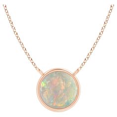 Featuring a simple yet elegant design, this 18k rose gold opal solitaire necklace is sure to fascinate. The bezel set cabochon opal allures with its delightful play of colors. Available in different carat weight. Opal is the Birthstone for October and traditional gift for 12th & 14th wedding anniversaries. Free Certificate of Authenticity. All items are packaged with care in appealing boxes with plush interiors. Bezel Set Cabochon, Solitaire Necklace, Sapphire Solitaire, Round Solitaire, Garnet Pendant, American Modern, Solitaire Necklaces, Sapphire Pendant, Solitaire Pendant