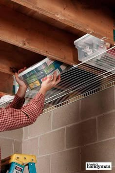 a man reading a magazine while hanging from the ceiling