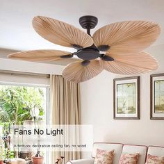 a living room with a couch, table and ceiling fan that is made out of pleated fabric