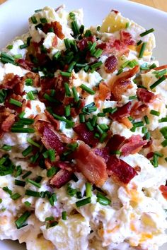 potato salad with bacon and chives on a white plate