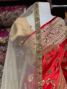 Bright Red Banarasi Silk Saree with an ensemble of fine work beads, pearls and sequins highlight intensifies the look of the Saree. Cut dana and zari work makes it a must way outfit for every bride to be. The saree has an unstitched blouse and a contrasting net dupatta is another great way to add it to your bridal wear. Fabric: Pure Silk Custom designed according to client measurements and color preference. Production and delivery time is 120 days! Festive Red Traditional Designer Wear, Transitional Red Dupatta With Gota Work, Elegant Red Sharara With Dori Work, Transitional Red Raw Silk Sets, Transitional Season Red Raw Silk Sets, Red Zari Work Sets With Traditional Drape, Red Sets With Zari Work In Traditional Drape, Red Kundan Anarkali Set With Gota Work, Unstitched Red Traditional Wear With Gota Work