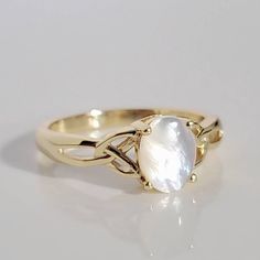 Wearing A Celtic Ring Symbolizes Friendship, Love And Loyalty Throughout The World. With Their Distinctive Design, These Rings Are Easily Recognizable And Can Trace Their History Back Several Hundred Years To The Rugged Irish Coast. Top Of Ring Height: 8mm Top Of Ring Width: 6mm Band Width: 3.2mm Shank Width: 1.8mm Stone Material: Mother Of Pearl Center Stone Size: 8mm X 6mm Stone Shape: Oval Total Number Of Stones: 1 Stone Setting: Prong Metal: 925 Sterling Silver Plating: 14k Yellow Gold Finis Gold Celtic Engagement Ring, Scottish Jewellery Ring, Celtic Wedding Ring Sets Gold, Irish Promise Rings Celtic Knots, Rings Gold Antique, Mother Rings Gold, Meaning Of Claddagh Ring, Greek Inspired Wedding Ring, Middle Earth Ring