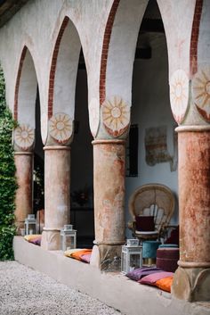 an old building with arches and sunbursts painted on the wall, along with other decorations