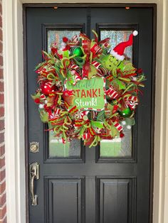 a christmas wreath on the front door of a house that says thank you stani stork