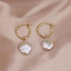 Type:    PEARL  HOOP EARRINGS Pearl color:Natural white Pearl size:12-14mm  Pearl shape:Coin Pearl luster: Very high  Pearl blemish: 90% free Material:   14K Gold Plated on Brass Feature: 15mm Hoops with 12-14mm Fresh Water Coin Pearl Please Note: Due to the variance of the natural pearls, size measurement is approximate, and color may vary a little. Round Hoop Earrings With Baroque Pearl Drop, Delicate Round Pearl Earrings With Pendant, Wedding Huggie Pearl Charm Earrings, Delicate Round Pearl Pendant Earrings, White Round Huggie Earrings With Pearl Drop, Round Huggie Earrings With Pearl Charm As Gift, Round Baroque Pearl Drop Hoop Earrings, Baroque Pearl Drop Dangle Hoop Earrings, Wedding Pearl Huggie Earrings