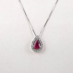 "White gold 14k necklace set with a pear shaped natural ruby 6×4 mm, 0.45 carat, surrounded by 16 halo round diamonds of 0.14 carat weight VS-G grade. Including a box chain 18\" Long. The ruby and diamonds are 100% natural of a very high quality, the diamonds are full of sparkle. The pear shape ruby weights 0.45 carat is full of rich color, surrounded by a halo of 16 diamonds of 0.14 carat VS-G Gold: 14k 1.90 gram (approx.) Chain: 16\"/18\"/20\" long Ruby: 0.45 carat, 6x4 mm, the ruby is natural Formal Ruby Drop Necklace, Formal Drop Ruby Necklaces, Formal Pear-shaped Ruby Necklace, Red Diamond Teardrop Necklace, Fine Jewelry Ruby Drop Necklace, Fine Jewelry Ruby Drop Necklaces, Red Teardrop Diamond Necklace, Red Gemstone Pear-shaped Necklace, Red Pear-shaped Gemstone Necklace