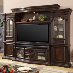 a living room with leather furniture and a flat screen tv mounted to the side of it