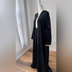 Message Me Your Size Available In (M, L, Xl) Model Is 5’5 Tall Medium Size And Abaya Is Floor Lenght On Model Introducing Our Caftan Abaya Dress With Hood - An Elegant, Modest Garment Perfect For Any Occasion. This Dress Boasts A Unique Design Featuring A Hood, Adding A Touch Of Sophistication To Your Wardrobe. Crafted With High-Quality Materials, This Caftan Abaya Dress Is Both Comfortable And Durable. Its Loose-Fitting Design Allows For Easy Movement And Breathability, While The Hood Provides Long Thobe With Modesty Panel For Eid, Black V-neck Abaya For Eid, Modest Long Abaya For Eid, Long Abaya With Modesty Panel For Eid, Eid Abaya With Modesty Panel, Long Modest Abaya With Dabka, Abaya Luxury, Plus Size Abaya, Abaya Modest