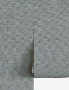 the side view of a gray suit with white buttons on it and an empty piece of paper next to it