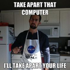 a man with an apron on standing in a kitchen