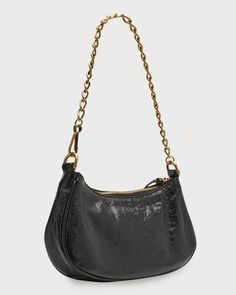 Balenciaga 'Le Cagole' shoulder bag in lambskin leather.Features signature studs and buckles.Detachable chain top handle.Detachbable, adjustable shoulder strap.Can be worn as a top handle or shoulder bag.Zip top closure.Interior, two card slots.Approx. 5.1H x 8.2'W x 1.7'D.Made in Italy Chic Evening Baguette Bag With Chain Strap, Formal Leather Baguette Bag With Chain Strap, Evening Baguette Bag With Chain Strap, Leather Baguette Bag With Chain Strap For Everyday Use, Luxury Baguette Bag With Chain Strap For Everyday Use, Chic Leather Baguette Bag With Chain Strap, Everyday Leather Shoulder Bag With Chain, Trendy Leather Baguette Bag With Chain Strap, Luxury Leather Baguette Bag With Chain Strap