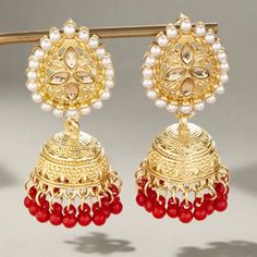 The versatile Cassie Jhumka Earrings are the ideal addition to any collection. Featuring just the right size and delicate details, these earrings can be dressed up or down to suit your style. Embrace their versatility and elevate any outfit with this must-have accessory. *This Product takes a Minimum of 30days to Ship* Red Chandelier Earrings For Festive Parties, Red Chandelier Earrings For Party And Festive Occasions, Festive Red Chandelier Earrings For Party, Elegant Red Danglers For Festive Occasions, Elegant Red Danglers For Festive Events, Bollywood Style Red Chandelier Earrings Gift, Red Hoop Earrings With Latkans For Gift, Red Hoop Earrings With Latkans As A Gift, Red Bollywood Chandelier Earrings For Gift