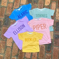 Monochrome name shirts! Personalize with name, or nicknames like babe, sister, or brother! These are great for family pictures, name announcements, gender reveals, and everyday wear! Choose from blue, pink, sage, lavender, or mustard 100% poly shirts. These tees have a cotton feel and are SO soft!  My shirts are all handmade using the sublimation process. The image is printed on an 100% polyester tee through a professional printing process. The ink infuses with the fibers, making the design part Fun Customizable Cotton Shirt, Customizable Pink Graphic Tee, Fun Letter Print Tops For Family Occasions, Cute Family Shirt With Name Print, Playful Crew Neck Top With Name Print, Playful Letter Print Tops For Playtime, Customizable Fun Tops For Family, Fun Letter Print Tops For Playtime, White Crew Neck Top With Custom Name