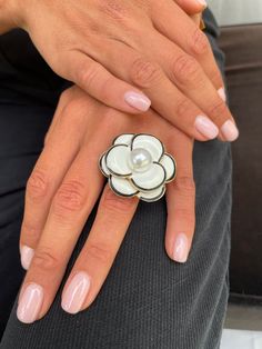 A super chic camellia ring. Ideal for total black and total white looks. It looks amazing when wearing pearls. Classy and super elegant, this eye catching ring will add an interesting twist, to a multitude of looks. Extremely sculptural, it always adds character. Unique and super stylish, an easy piece that you will use a lot and always love. A timeless classic. The ring is shipped in a beautiful black black box. For long distance gifting, please provide your details in the personalisation field Luxury White Flower Ring For Anniversary, Elegant White Flower Open Ring, Elegant White Open Flower Ring, Elegant White Flower Shaped Ring, Elegant White Enamel Wedding Ring, Elegant White Flower Shape Ring, Elegant White Flower-shaped Ring, Elegant White Enamel Ring For Gift, Luxury White Flower Shaped Ring