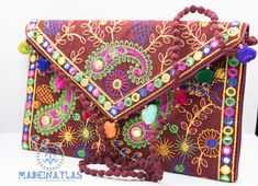 This beautiful Colorful clutch bag is handmade in Morocco. This bohemian Moroccan tassel clutch bag is fun and colorful. The embroidered clutch is the perfect accessory to carry with you for parties and other festive occasions. This beautiful little hippie clutch purse is handmade with embroidered fabric, venetian patterns and colorful pom pom's to trim. This Pom Pom clutch bag features a magnet opening and a zippered pocket inside. This adorable little floral crossbody bag will be sure to turn a few heads with its colorful features! This Colorful Clutch is the ultimate boho-chic accessory. This gorgeous bohemian clutch bag is the perfect accessory to give a unique look to your casual outfits or night out events. Can be also used as an amazing iPad case. Handcrafted by talented artisans us Festival Party Bags With Tassels, Party Bags With Tassels For Festivals, Bohemian Clutch Bag With Tassels, Bohemian Tassel Clutch Bag, Handmade Multicolor Evening Bag For Festivals, Multicolor Handmade Evening Bag For Festivals, Bohemian Clutch Shoulder Bag With Tassels, Bohemian Tassel Clutch Shoulder Bag, Handmade Bohemian Evening Bag For Festive Occasions