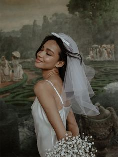 a woman holding a bouquet of flowers in front of a painting