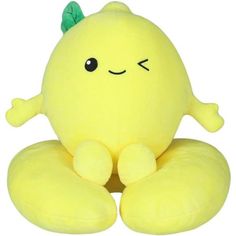 a yellow stuffed animal sitting on top of a pillow