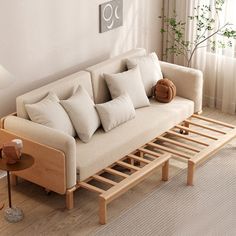 a living room with a couch, coffee table and lamp on the floor next to it